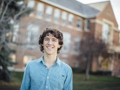 MSU student in from of Roberts Hall