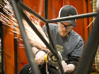 student showering sparks as he grind a metal frame