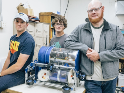 photo of three students standing by their robosub