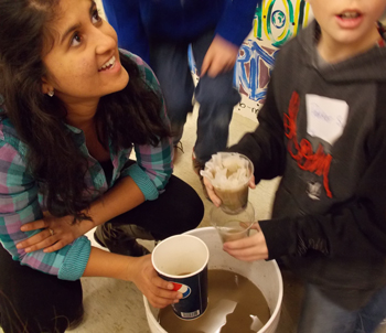 Undergraduate student helps elementary student filter water