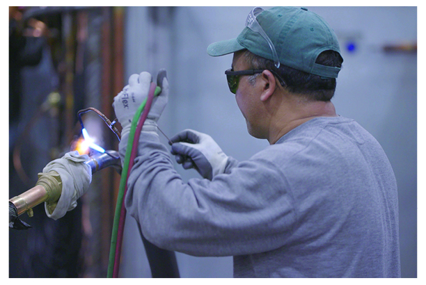 An AAON employee welds an HVAC part at AAON’s manufacturing facility in Tulsa, Oklahoma.